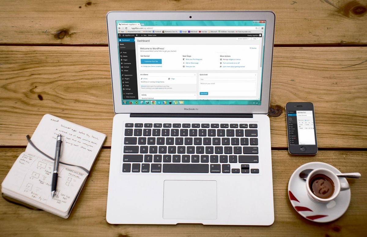 Clean laptop workspace with notebook and coffee, representing a lean and fast WordPress site